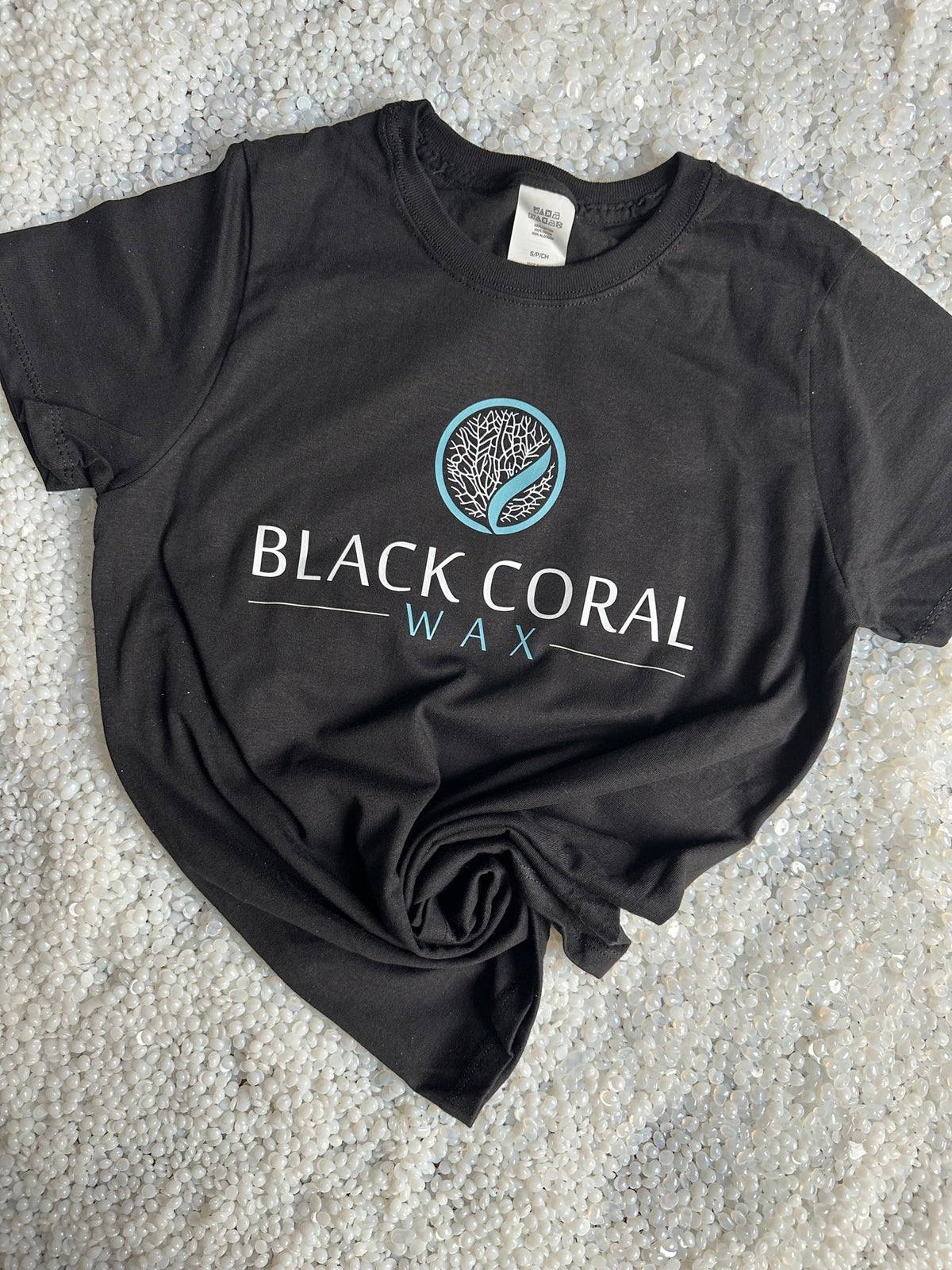 Black unisex Black Coral Wax T-shirt with turquoise and white front logo, short sleeves and round neckline